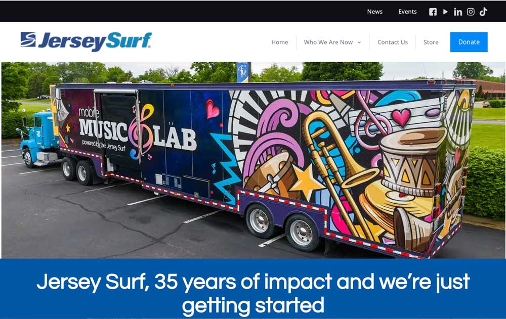 Jersey Surf homepage with a photo of the full-size Mobile Music Lab tractor-trailer in its colorful instrument wrap, above a blue banner reading “Jersey Surf, 35 years of impact and we're just getting started”